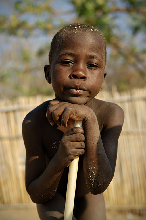 Jeune garçon qui s'appuie sur un bâton à Cape Maclear, Malawi