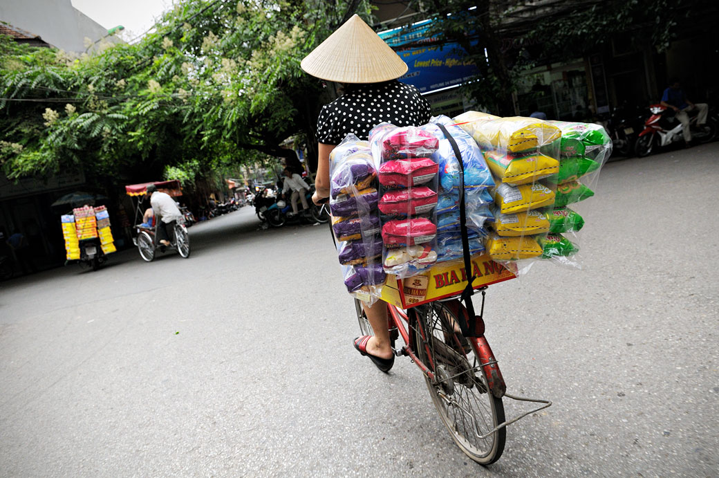 Femme sur un vélo chargé à Hanoi, Vietnam